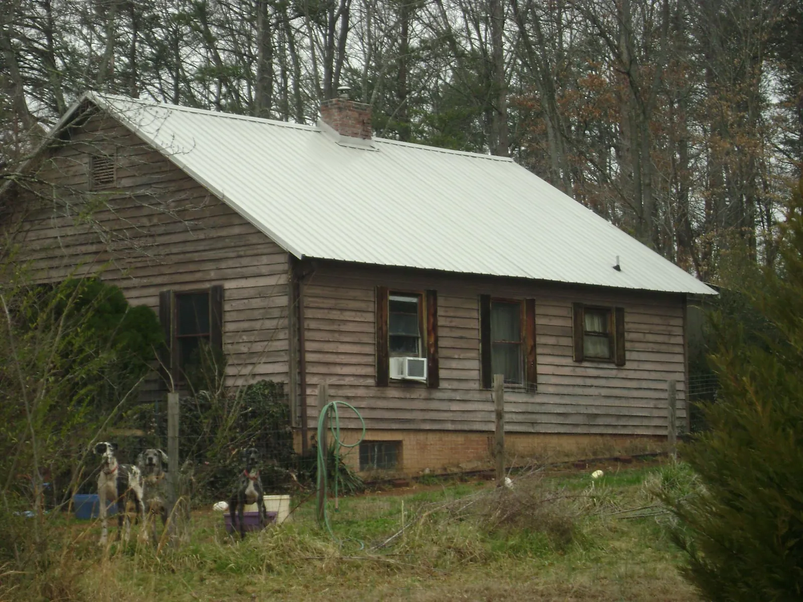 White metal roof on an old wood sided farmhouse, from a Metal Roof Installation job in South Grafton